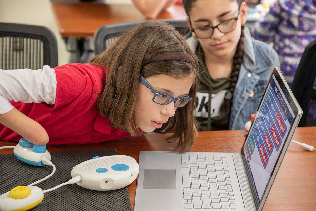 A student reads the Code Jumper app while using Code Jumper